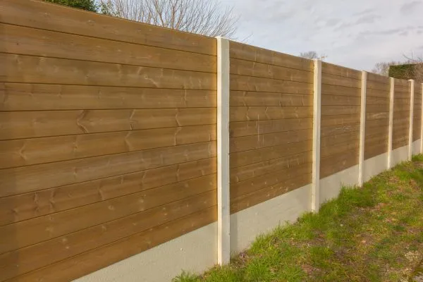 Photo of a newly installed wooden fence with concrete posts and gravel boards by Stephen Paul Gardens.